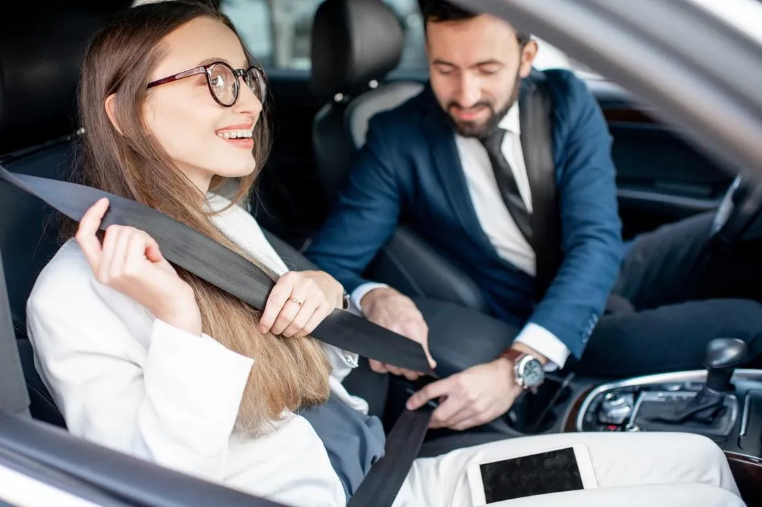 Chauffeur helping secure a passenger safely