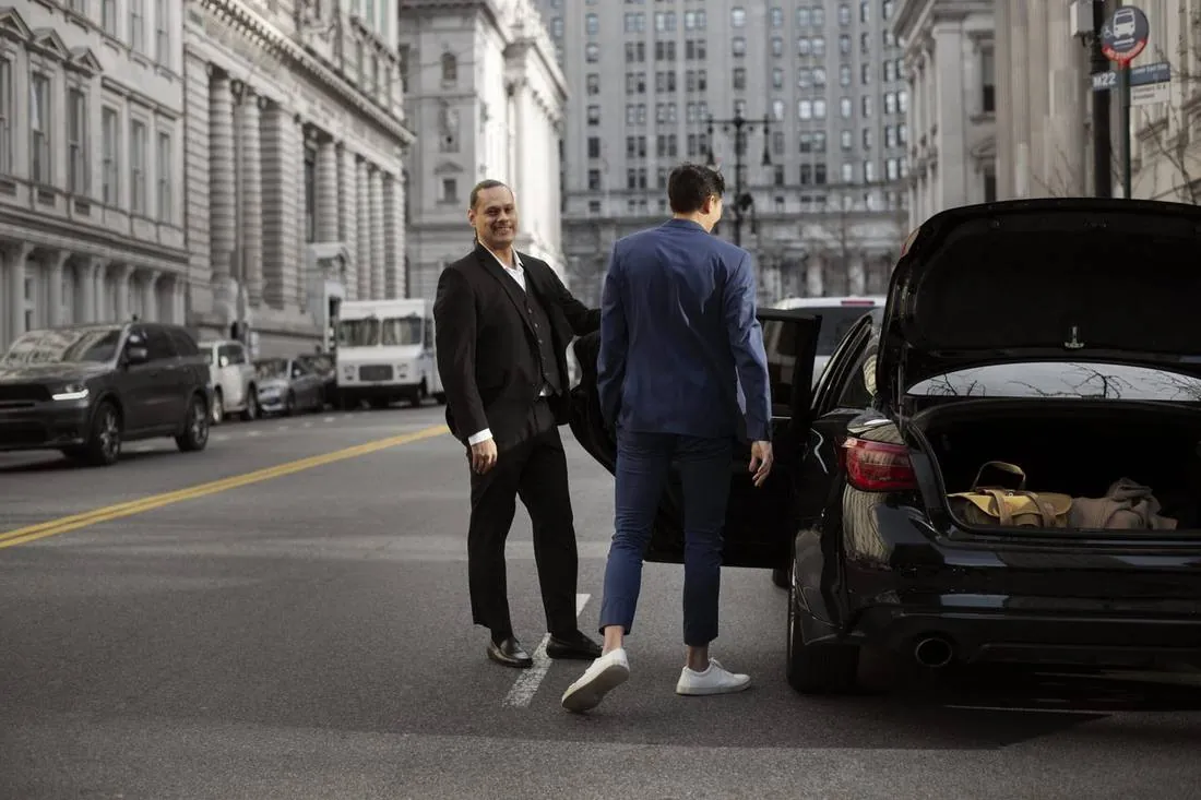 Chauffeur assisting a passenger during a point to point ride in Dallas